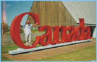 Don Woolcock pictured with full size Canada  letters sign