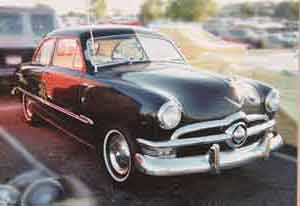 1950 Ford 2 Door Black with turn signals built into the steering wheel